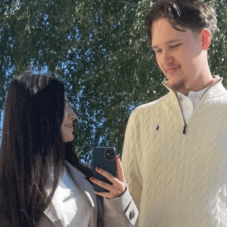 Julian Sallaberger with Maria, outdoors in front of a birch tree